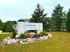 Charming Edge at 10101 Apartments entrance with stylish signage, lush landscaping, and welcoming stone accents.