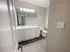 Modern bathroom with dual sinks and elegant lighting, showcasing spacious cabinets and contemporary design.