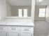 Modern apartment featuring elegant marble countertops, bright open living space, and large windows for natural light.