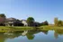 Charming lakeside townhomes surrounded by lush greenery and serene landscapes, perfect for tranquil living.