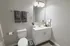 Modern bathroom with elegant fixtures, showcasing a sleek vanity, decorative elements, and soft lighting for a soothing ambiance.
