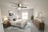 Elegant bedroom with a cozy bed, modern decor, and abundant natural light, offering a serene retreat.