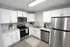 Modern kitchen with sleek stainless steel appliances, elegant white cabinetry, and stylish decor accents.