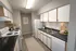 Charming modern kitchen with sleek countertops, white cabinetry, and stainless-steel appliances, offering a cozy and inviting culinary space.