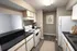 Chic kitchen with modern appliances, sleek black countertops, and stylish cabinetry, perfect for culinary creativity.