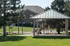 Charming outdoor area with playground equipment and a covered pavilion, perfect for family gatherings and relaxation amidst lush greenery.