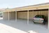 Spacious covered parking area with well-lined spaces and secure shelter, featuring a parked vehicle.