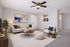 Inviting living room with elegant neutral tones, modern furniture, and stylish decor, featuring a cozy beige sofa and a vibrant wall painting.
