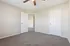Inviting and spacious bedroom with plush carpet, neutral walls, and modern ceiling fan, perfect for personalizing your sanctuary.