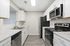 Contemporary kitchen with sleek stainless steel appliances, elegant white cabinetry, and polished countertops for a modern touch.