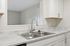 Modern kitchen with elegant marble countertops and sleek stainless steel fixtures.