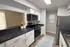 Contemporary kitchen with sleek stainless steel appliances, elegant white cabinetry, and a bright, inviting atmosphere.