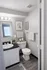 Elegant bathroom featuring modern fixtures, sleek counter, and tasteful decor with plush towels and candles.