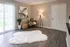 Inviting living room with chic decor, soft ambient lighting, and plush white rug on elegant hardwood floors.