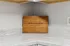 Elegant kitchen corner with a custom wooden cutting board engraved with 'The Overlook At Ashland, Established 2025' resting on pristine marble countertops.