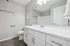Elegant bathroom with modern fixtures, sleek white cabinetry, and polished countertops, creating a clean and inviting atmosphere.