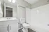 Modern bathroom design featuring sleek fixtures, a pristine bathtub, and stylish vanity with ample storage.
