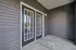 Inviting patio area with elegant French doors leading to a cozy outdoor space, perfect for relaxation.