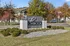 Inviting entrance sign for The Overlook at Ashland, beautifully framed by lush greenery and vibrant autumn trees.
