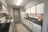 Charming kitchen with modern appliances, sleek countertops, and warm wood cabinets, ideal for culinary enthusiasts.