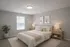 Elegant bedroom with a cozy, modern design featuring a plush bed, stylish lamps, and minimalist decor.