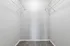 Spacious walk-in closet with sleek wire shelving and plush carpet, offering ample storage and modern elegance.
