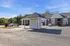 Inviting apartment complex exterior featuring convenient covered mail station and ample parking, surrounded by lush greenery and a peaceful atmosphere.