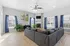 Bright and inviting living room with a cozy sectional sofa, modern fireplace, and large windows providing ample natural light.