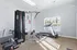 Bright and modern gym room featuring a state-of-the-art treadmill and versatile weight machine, ideal for a comprehensive workout experience.