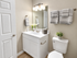 Modern bathroom with elegant white vanity, soft lighting, and stylish fixtures creating a luxurious feel.