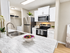 Modern kitchen with sleek countertops, stainless steel appliances, and elegant decor, featuring convenient in-unit laundry facilities.
