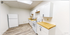 Charming kitchen with modern white cabinetry, sleek wooden countertops, and stainless appliances, perfect for culinary adventures.