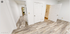 Bright and modern interior showcasing sleek wood flooring, spacious rooms, and crisp white doors.