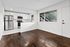 Bright and modern kitchen with sleek stainless steel appliances, elegant white cabinetry, and a large window offering a view of the outdoors. The space features stylish hardwood flooring and ample natural light.