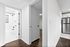 Sleek apartment interior featuring a modern bathroom with stylish fixtures, elegant hallway, and a stainless steel refrigerator in view.
