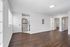Elegant apartment interior featuring sleek stainless steel kitchen appliances, rich hardwood flooring, and bright natural lighting.
