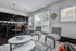 Modern open living area with sleek kitchen, stylish bar stools, and abundant natural light from large windows, perfect for entertaining.