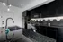 Sleek modern kitchen with glossy black cabinets, elegant hexagonal backsplash, and polished granite countertops.