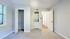 Bright and airy bedroom with a spacious closet and in-unit washer dryer, featuring soft carpet and modern finishes.