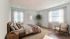Bright and airy bedroom with a cozy bed, stylish decor, and abundant natural light, offering a peaceful retreat.
