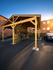 Modern wooden bicycle shelter in a vibrant apartment complex with ample parking space, perfect for active urban living.
