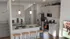 Modern kitchen with elegant pendant lighting, stainless steel appliances, and a cozy breakfast bar with wooden stools. Perfect for entertaining and culinary adventures.