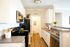 Pittsburgh PA Apartments - Bear Run Village - Kitchen With Wood-Style Flooring, Grey Countertops, White Cabinetry, Stainless Steel Appliances, And A Laundry Closet