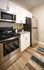 Dog-Friendly Apartments in Plymouth Meeting, PA - Plymouth Pointe - Kitchen with Stainless Steel Appliances, White Cabinets with Grey-Granite Countertops, and Wood-Style Plank Flooring