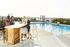 Apartments Near West Side Market - The Shoreline - Gated Pool with Bar Table, Seating, and Lounge Chairs.