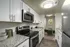 Contemporary kitchen with sleek granite countertops, stainless steel appliances, and a view into a cozy dining nook.