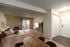 Spacious living room with elegant furniture, large sliding glass doors, and a view of lush greenery.