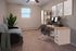 Modern home office with stylish desk, computer, and comfortable seating.