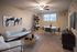 Inviting living room with elegant decor, featuring a plush white sofa, modern art, and a chic dining area.