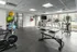 Well-equipped gym with exercise bikes, treadmills, and panoramic windows.